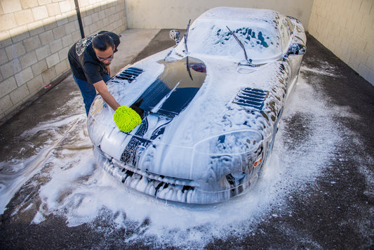 A car being hand-washed with a microfiber mitt in a Chemical Guys detailing photograph